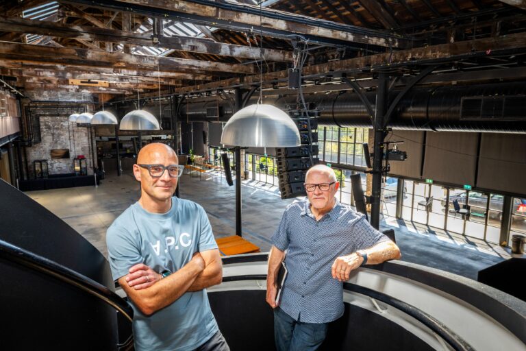 Work Beyond Walls organisers stand in the warehouse