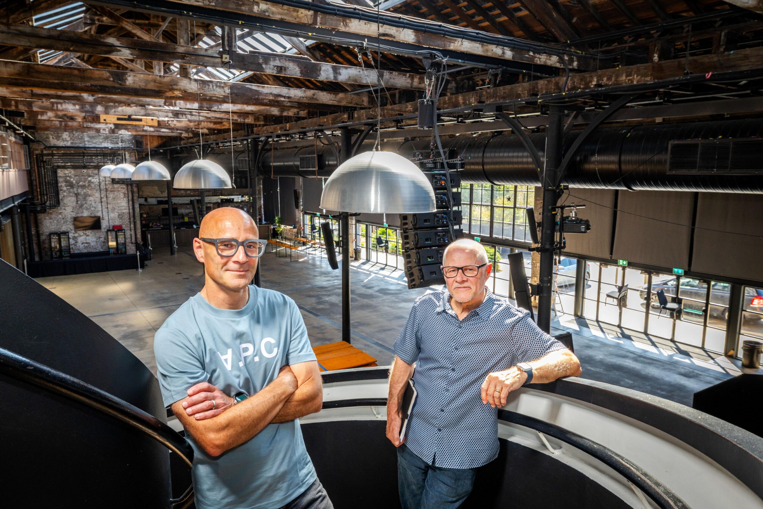 Work Beyond Walls organisers stand in the warehouse