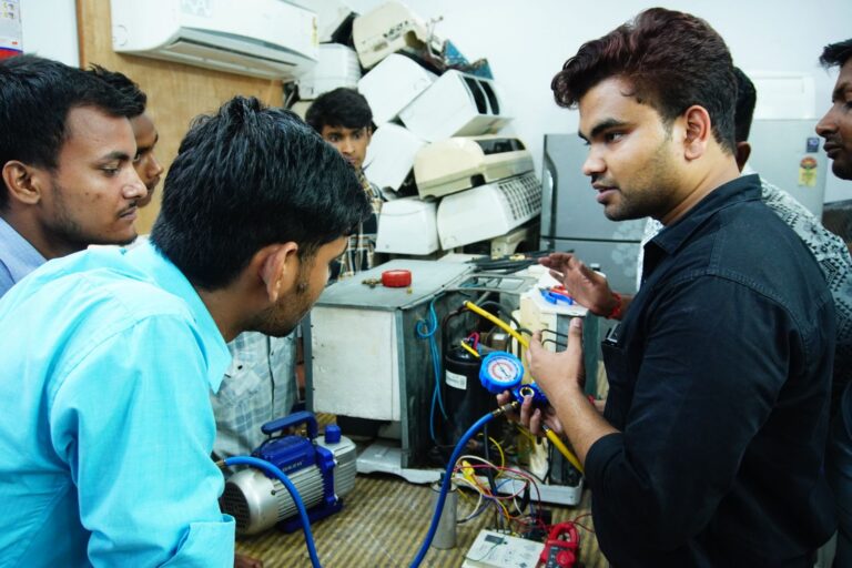 Adults learning a hands-on technical skill in a training workshop, reflecting career change in the AI jobs story