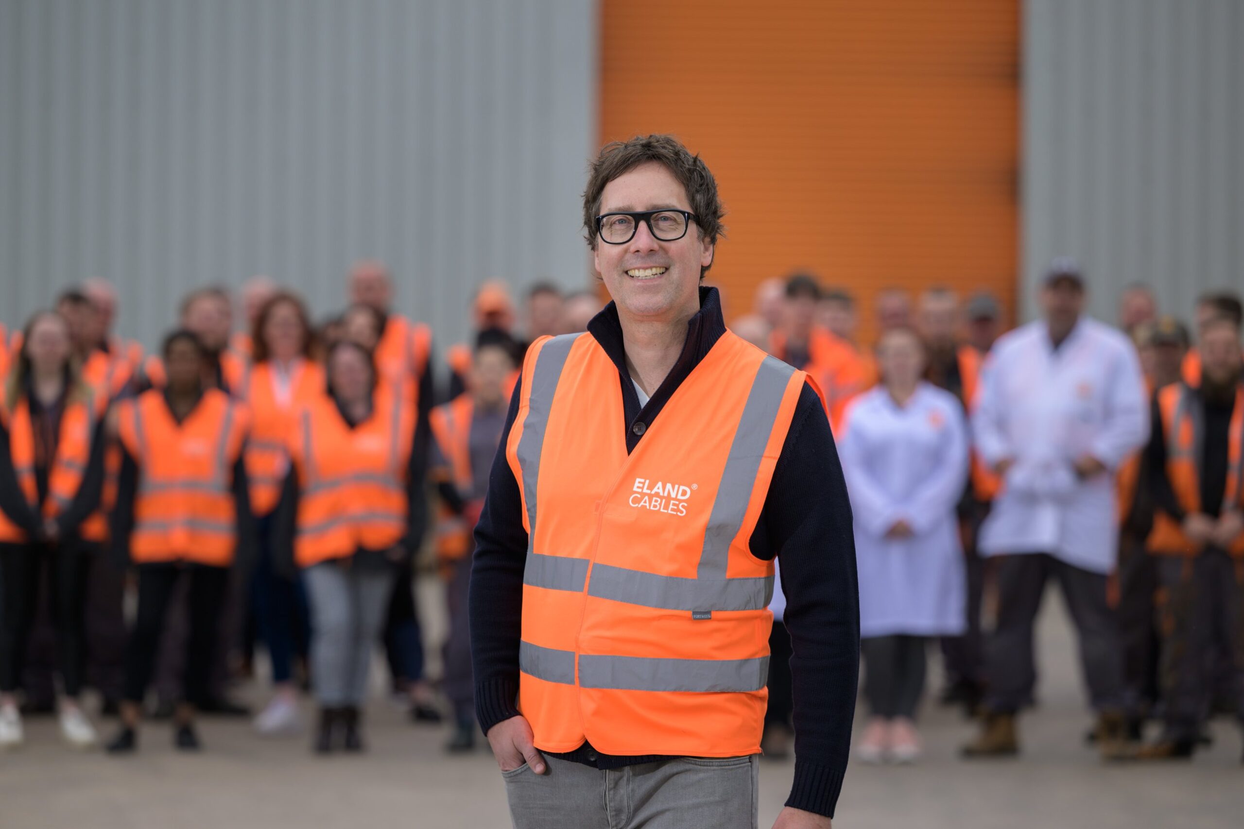 JS Pelland, Executive Director at Eland Cables, with warehouse staff, in a Real Living Wage staff retention story