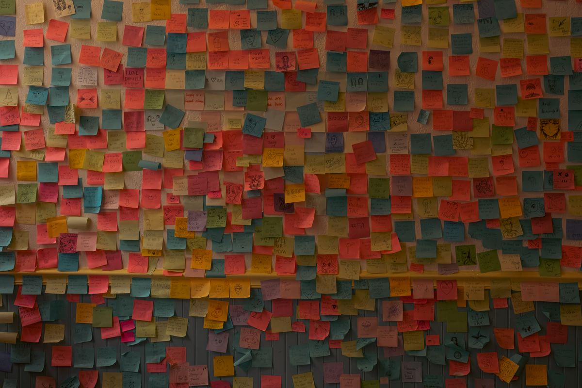 Gratitude wall at work made from colourful sticky notes on an indoor wall