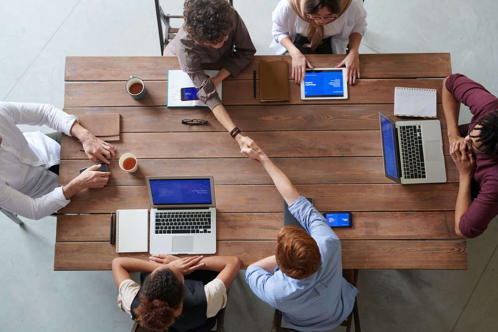 Colleagues seen from above working around a table on organisation design